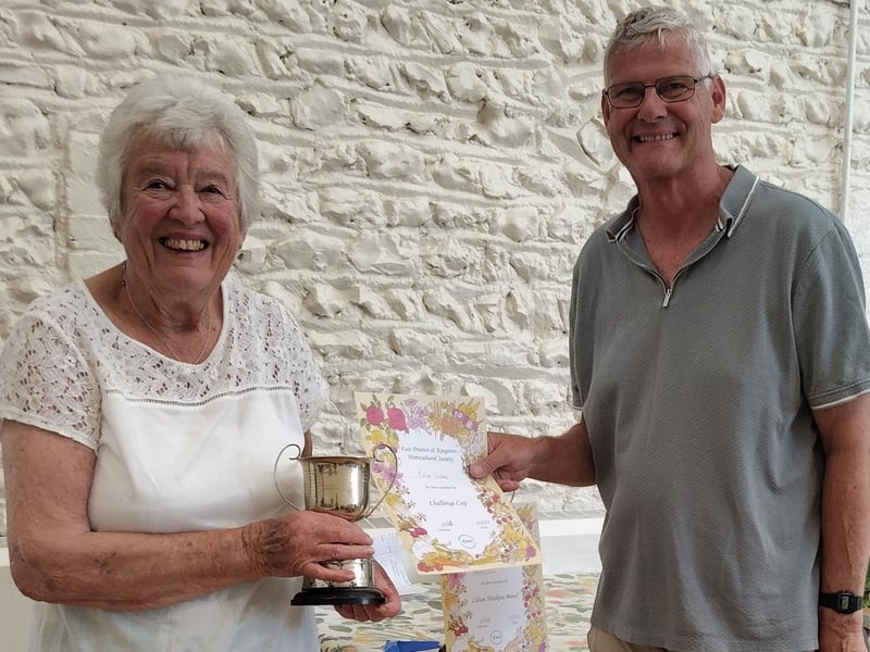 Joan Crane picks up the Springett Cup on behalf of her husband, Colin, who also won the Challenge Cup for best delphinium