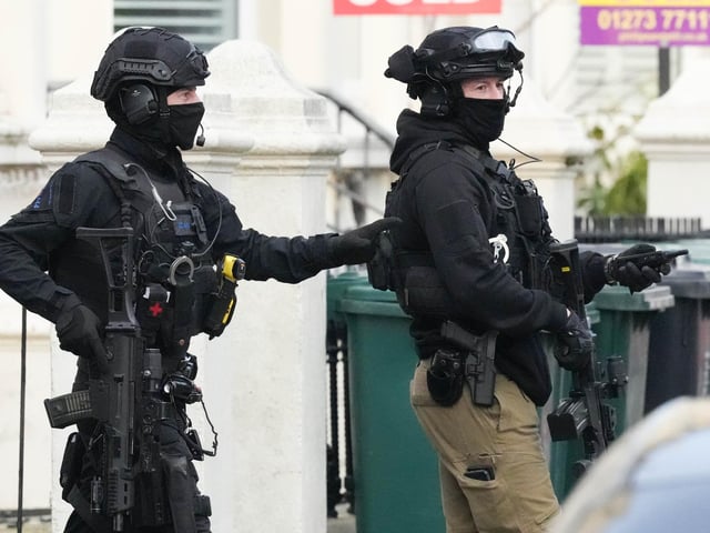 Photos show major police response and armed officers in Hove
