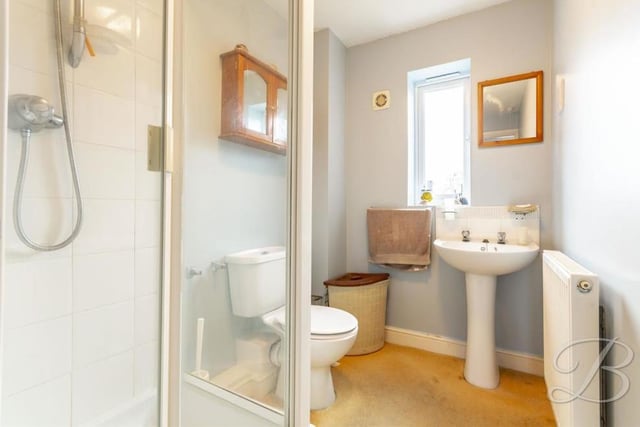 The main bedroom has the added luxury of en suite facilities. They comprise an enclosed shower, low-flush WC, pedestal sink, central heating radiator and opaque window to the back of the property.