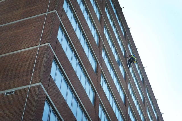 A worker fitting earthing strips on the side of Ocean House in St Leonards on May 15 2024.