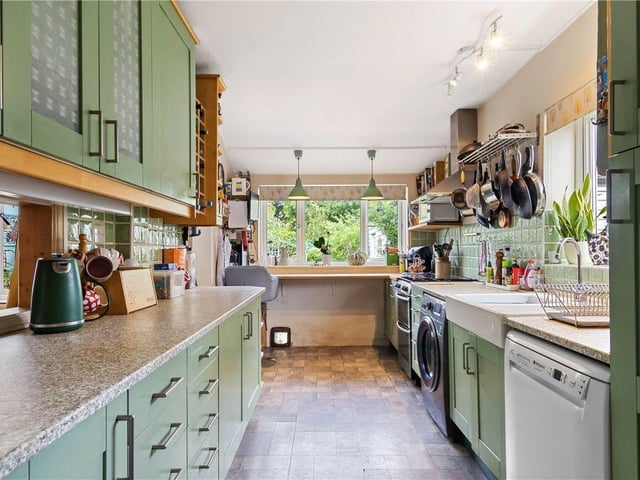 The beautifully equipped kitchen feels modern without sacrificing the property's 1930s charm.
