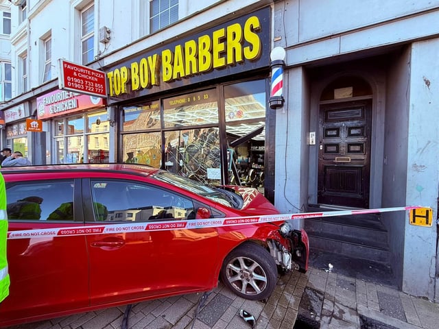 Photos from the scene show a red car had mounted the pavement, and collided directly into the front of a High Street barbershop.