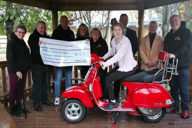 A student at Oak Grove College scoots up to collect a cheque