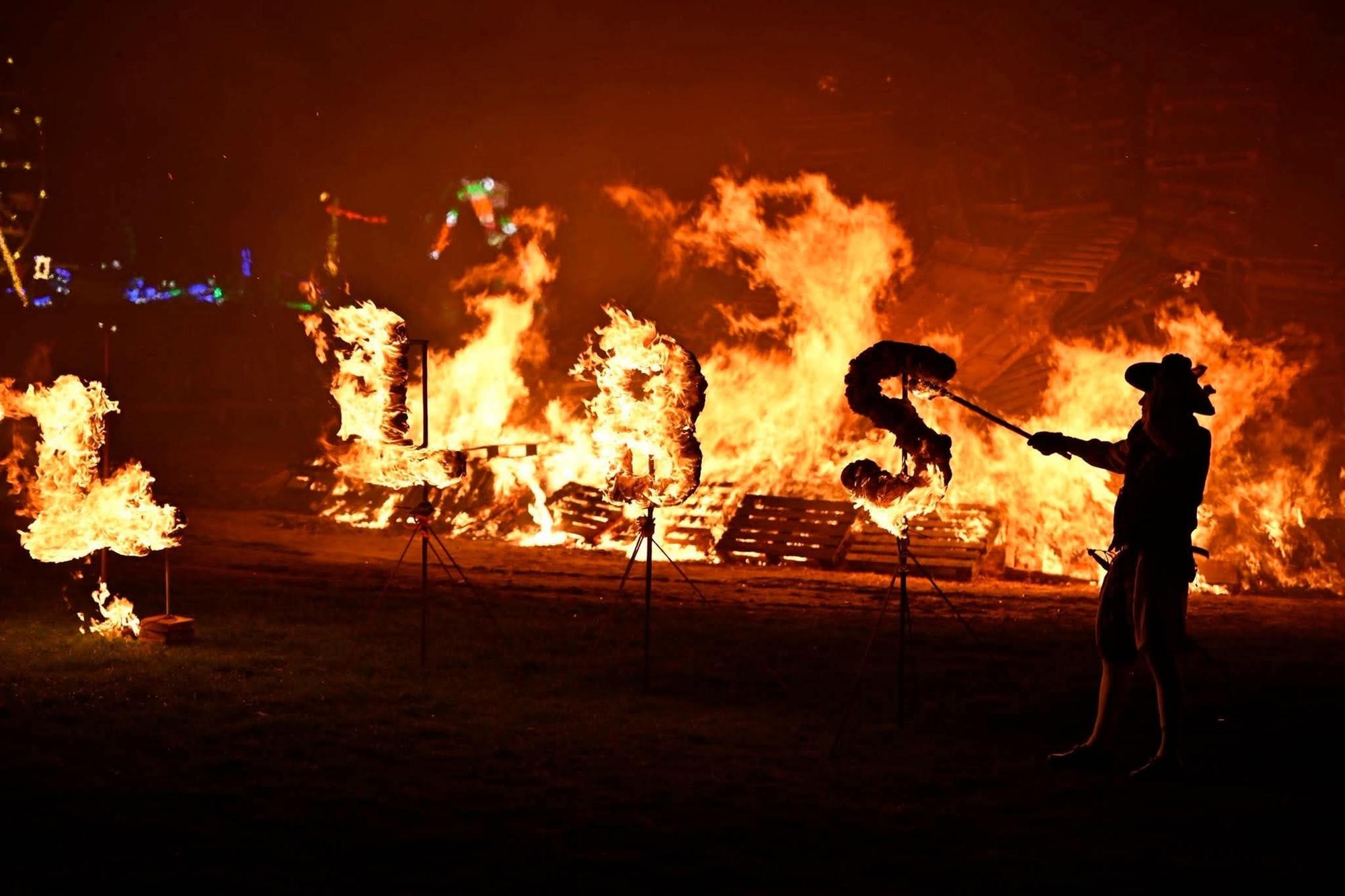 Members of the society lit the bonfire with their traditional flaming torches