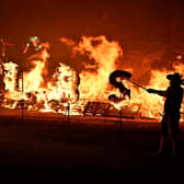 Members of the society lit the bonfire with their traditional flaming torches