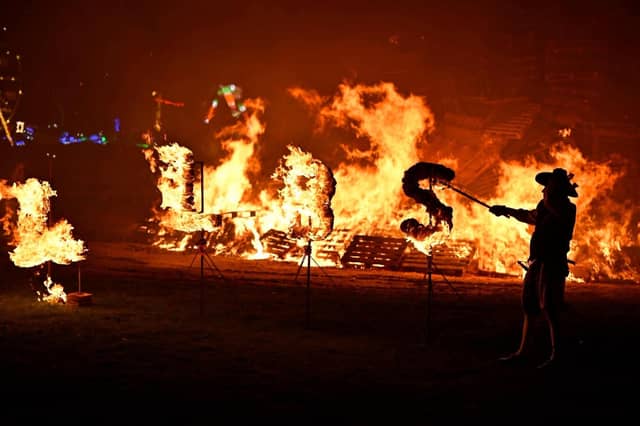 Members of the society lit the bonfire with their traditional flaming torches