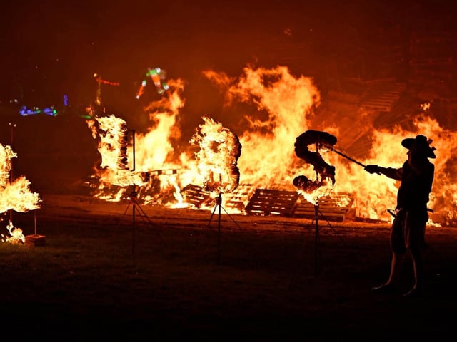 Members of the society lit the bonfire with their traditional flaming torches
