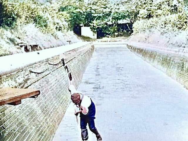 One of the two swimming pools in Ford Road being cleaned. These were filled with river water.