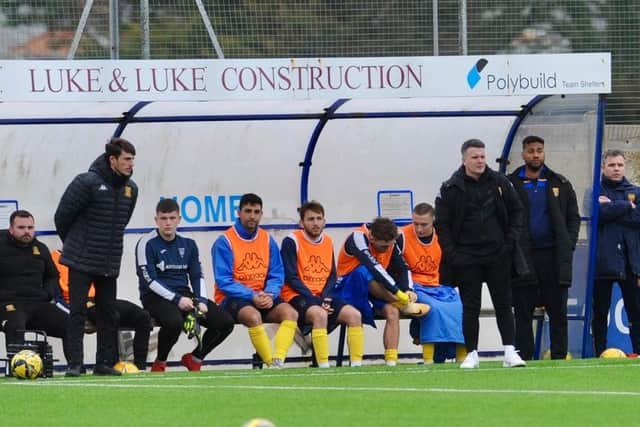 Dean Cox and staff in the Lancing FC dugout