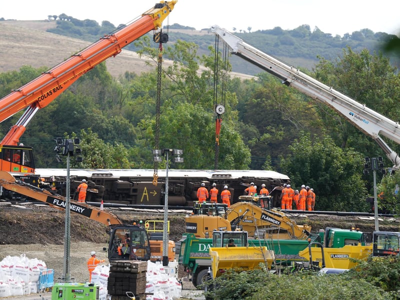 Two cranes seen lifting one of the carriages