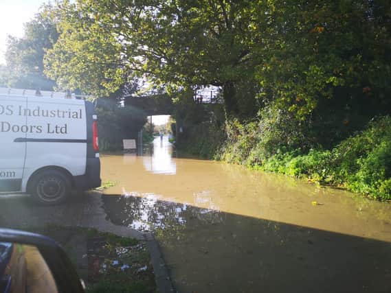 Heavy rain in the city has caused the area and roads around a major housing development in Chichester to flood.