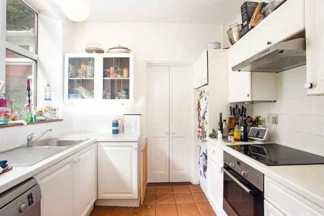 The traditional fully-fitted kitchen has an adjacent utility room