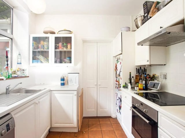 The traditional fully-fitted kitchen has an adjacent utility room