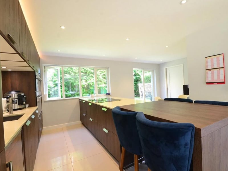 The kitchen has an island breakfast bar and dining area