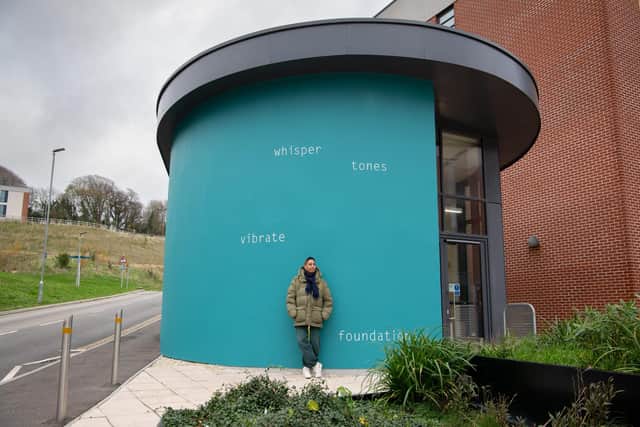 Helen Cammock in front of new University of Sussex Student Centre artwork