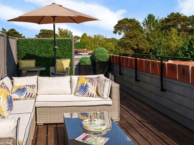 The private rooftop terrace, accessed via staircase, looks out over acres of countryside.