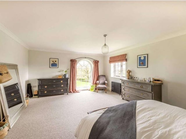 A central staircase leads upstairs from the entrance hall and divides at the first landing to provide stairs to the bedrooms which are split over two wings. The northern wing, where the principal suite is situated, comprises a spacious bedroom, dressing area and en suite bathroom