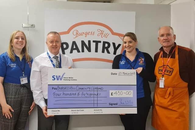 Steve Willis, managing director of Steve Willis Training, presente a cheque to volunteers from Burgess Hill Pantry, alongside representatives from Burgess Hill Town Council