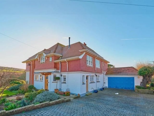 The cellar is painted throughout, with two separate rooms and partially shelved – ideal for storage. To the side is a driveway for several vehicles as well as a double garage and access to a workshop to the rear.
