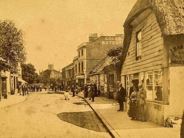 Littlehampton High Street in 1885, with James Findley outside the tailor's shop