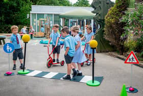 Rolls-Royce Motor Cars has donated a Road Safety Activity Kit to neighbouring March CE Primary School. Year R children are pictured learning how to cross the road safely. Photo: Rolls-Royce Motor Cars