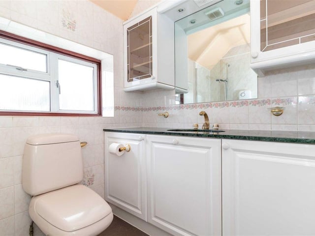 The family bathroom has a walk-in shower and built-in storage units