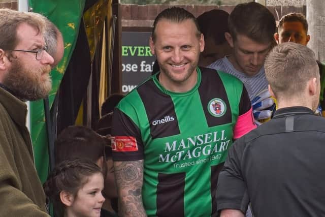Lewis Taylor prepares to lead out Burgess Hill last March - shortly before he was made manager | Picture: Chris Neal
