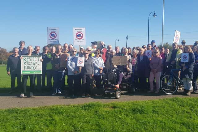 The protest took place on the Village Green on Tuesday, October 18, with residents and councillors waving banners and placards