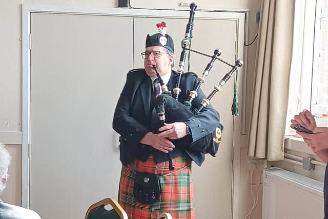 A bagpiper accompanied the arrival of the birthday cake, to honour Avril Andrew's half-Scottish ancestry