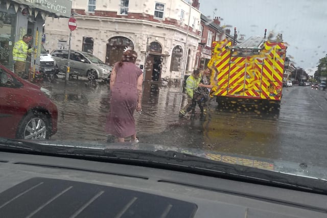 Stella Barnard wrote: "Notice a young lady being carried across the road by a fireman, with 'bride to be'sash over her."