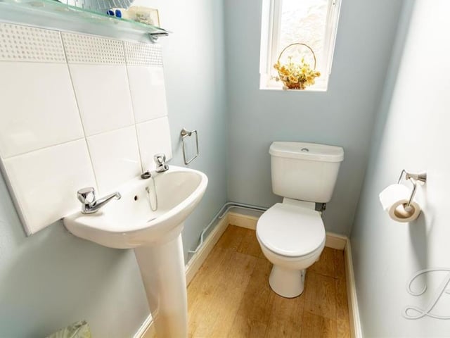A downstairs toilet is always handy. This is the one at Spindle Court, with a pedestal sink, low-flush WC and opaque window facing the back of the property.