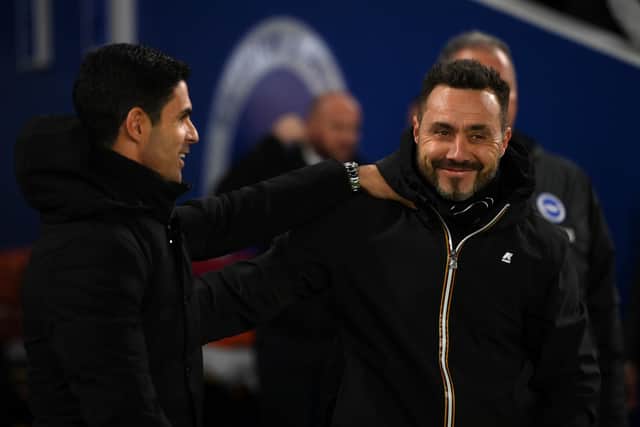 Mikel Arteta, manager of Arsenal, embraces Brighton boss Roberto De Zerbi. (Photo by Mike Hewitt/Getty Images)