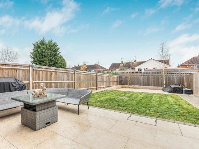 The property's garden is larger than average for a new build home and has a lawn area, two patio areas and a walkway up the side.