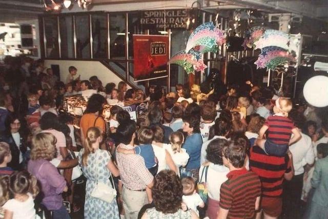 Crowds of people in Debenhams at Christmas time in the 1980s.