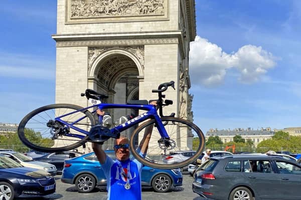 Ian with his bike at Arc de Triomphe, Paris