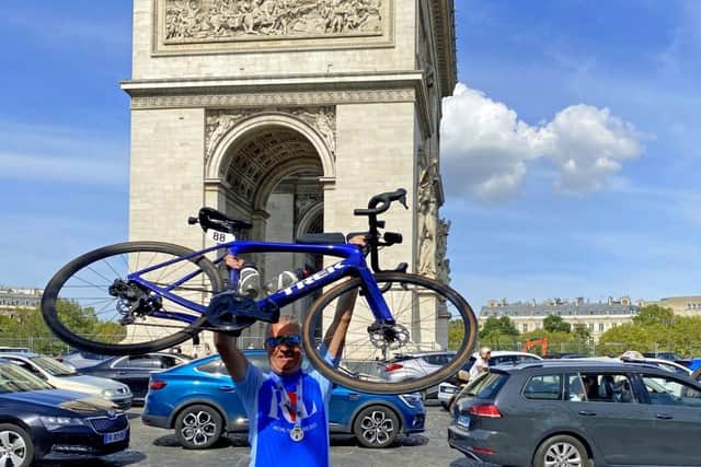Ian with his bike at Arc de Triomphe, Paris