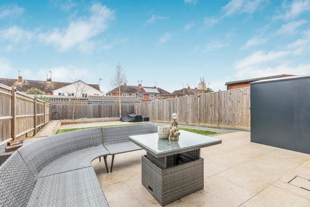 The property's garden is larger than average for a new build home and has a lawn area, two patio areas and a walkway up the side.