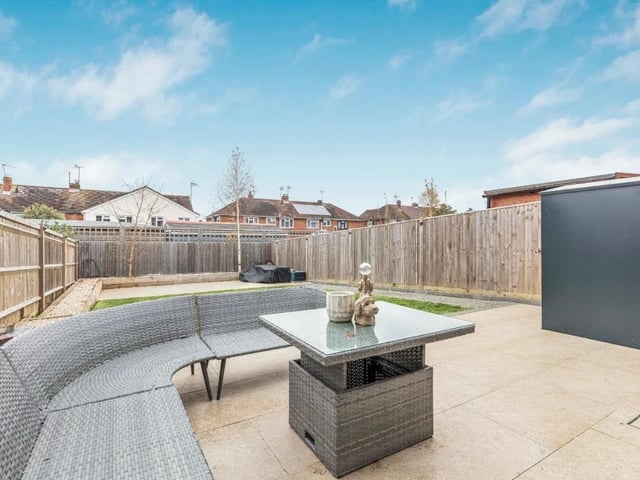The property's garden is larger than average for a new build home and has a lawn area, two patio areas and a walkway up the side.