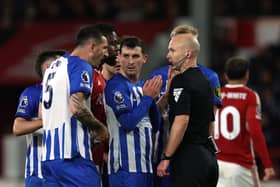 Lewis Dunk of Brighton & Hove Albion talks to Referee, Anthony Taylor during the Premier League match between Nottingham Forest and Brighton & Hove Albion at City Ground on November 25, 2023 in Nottingham, England. (Photo by Eddie Keogh/Getty Images)