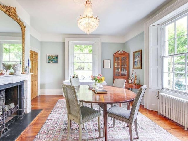The dining room also has a dual-aspect and features an original open fireplace