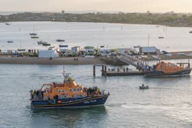Around 140 migrants arrive in Portsmouth, Hampshire after being transferred from a single dingy south of the Isle of Wight in the English Channel by two RNLI lifeboats, a mammoth operation is talking place on Sunday evening to process the illegal migrants, with dozens of government workers from Police, Border Force, Ambulance and Fire crews, along with a number of transport busses.  Dated 06/09/26.