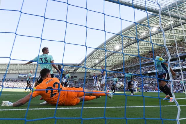 Nick Pope of Newcastle United makes a save on the line during the Premier League match between Brighton & Hove Albion and Newcastle United