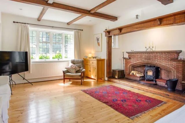 The dual aspect sitting room features a pretty fireplace