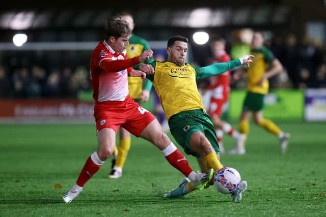 HORSHAM, ENGLAND - NOVEMBER 14: Tommy Kavanagh of Horsham is challenged by Luca Connell of Barnsley during the Emirates FA Cup First Round Replay match between Horsham and Barnsley at The Camping World Community Stadium on November 14, 2023 in Horsham, England. (Photo by Charlie Crowhurst/Getty Images)