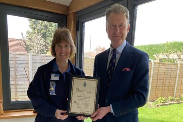 Wendy Colson, County Commissioner of Girlguiding Sussex Central County, receiving the High Sheriff Award from James Whitmore, High Sheriff of West Sussex