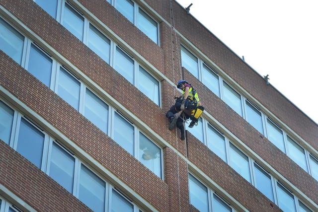 A worker fitting earthing strips on the side of Ocean House in St Leonards on May 15 2024.