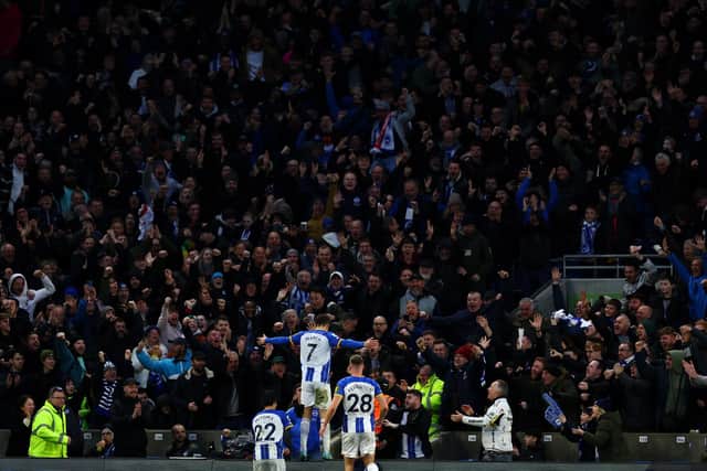 Solly March celebrated with the Brighton fans after scoring a brace against Liverpool (Photo by Bryn Lennon/Getty Images)