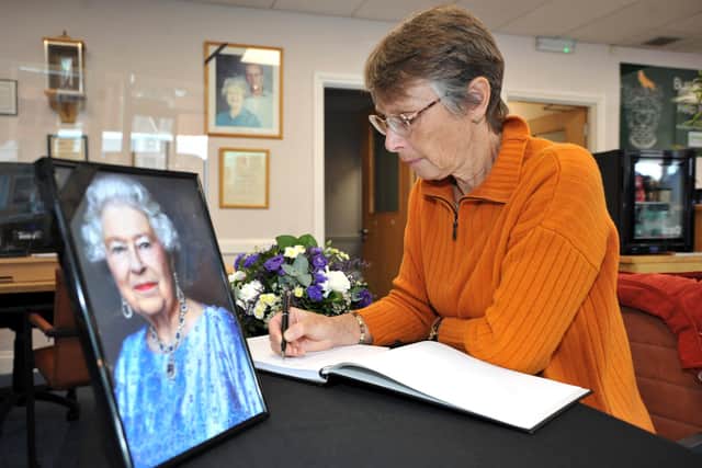 Former Burgess Hill town mayor Ann Eves signs the Queen's book of remembrance. Photo: Steve Robards, SR2209091