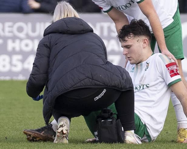 Ben Anderson is treated after he is injured against Cheshunt | Picture: Lynandtrev Sports