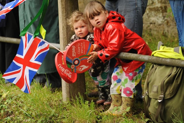 Youngsters at Duncton wait for the Olympic torch to pass